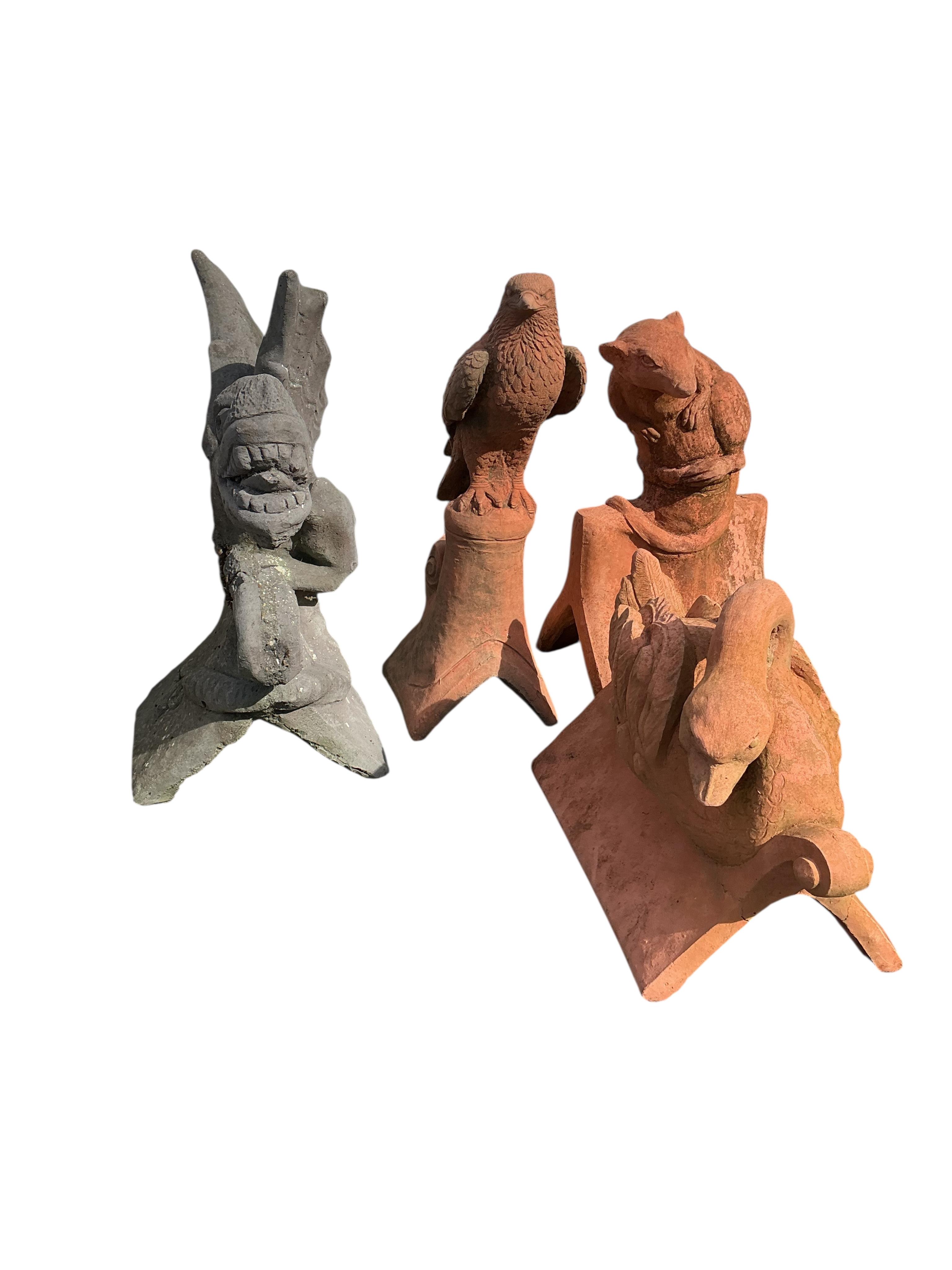 Four cast stone ridge tiles, largest height 56cm